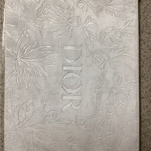 Dior white embossed make up bag.